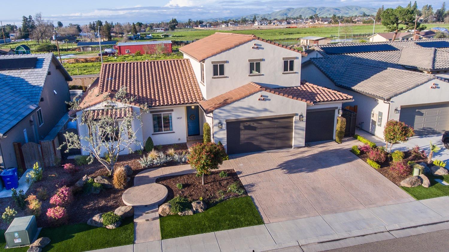1437 Jordan Avenue Clovis, CA 93611 - Photo 6 of 53 a front view of a house with a yard garage and outdoor seating
