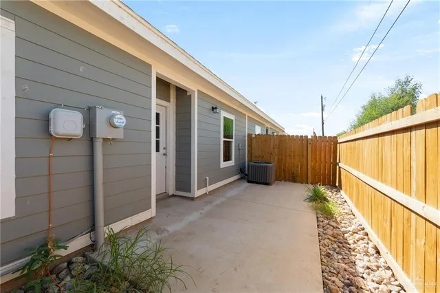 a view of a house with wooden fence