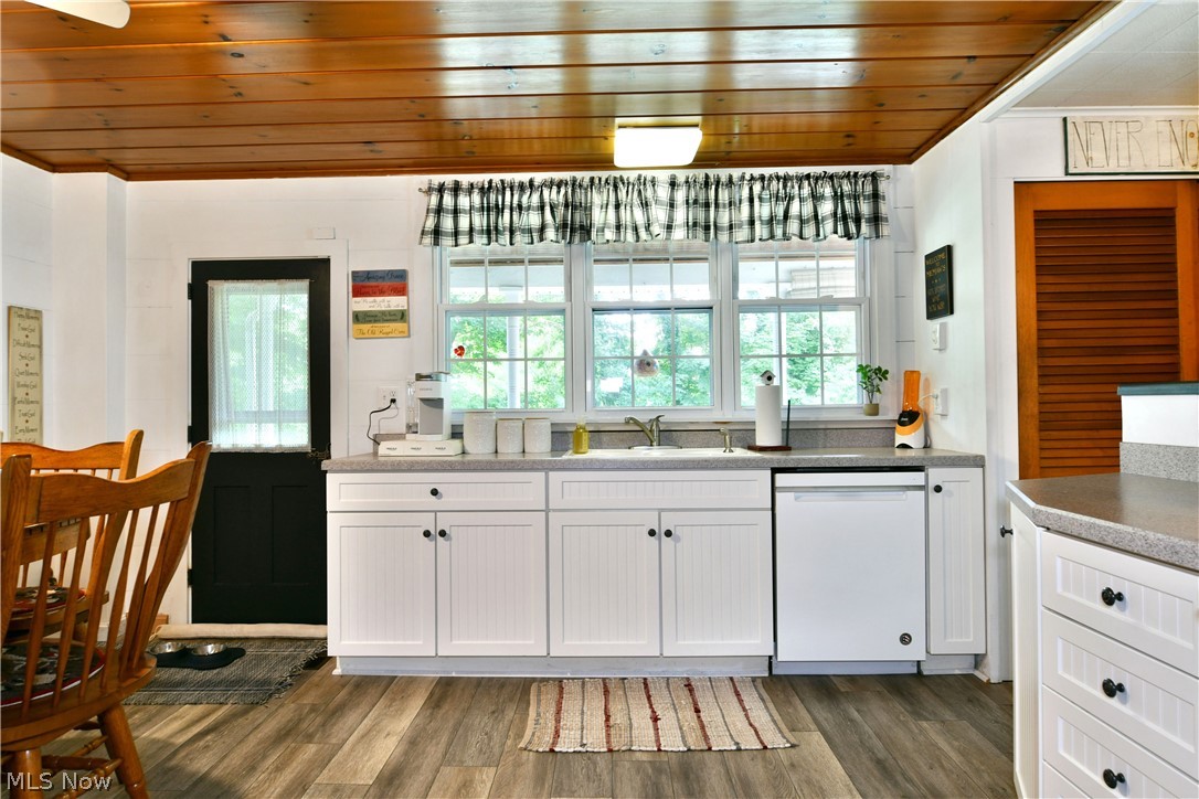 8683 King Graves Road Northeast Warren, OH 44484 - Photo 7 of 50 Bright kitchen featuring white cabinetry with beadboard paneling, light grey countertops, and a stainless steel sink