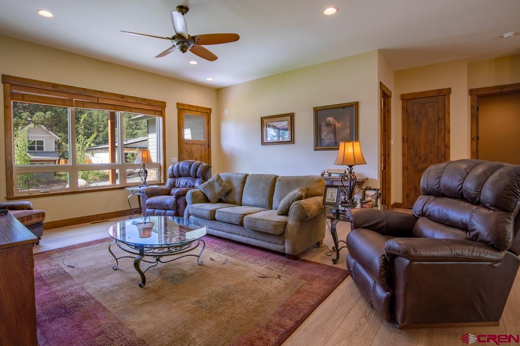 62 Manitou Lane Durango, CO 81301 - Photo 11 of 34 a living room with furniture a ceiling fan and a rug