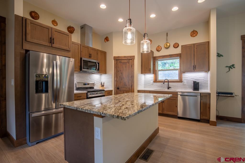 62 Manitou Lane Durango, CO 81301 - Photo 12 of 34 a kitchen with a refrigerator sink and microwave