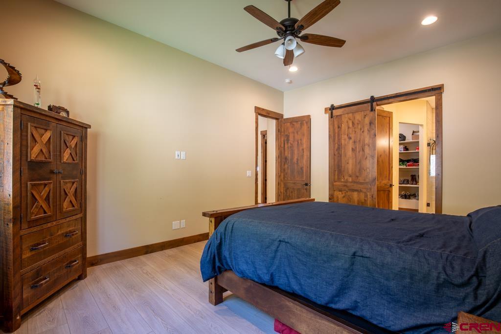 62 Manitou Lane Durango, CO 81301 - Photo 13 of 34 a bed sitting in a spacious bedroom next to a window