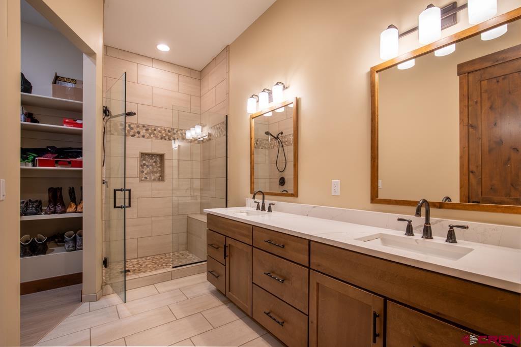 62 Manitou Lane Durango, CO 81301 - Photo 17 of 34 a bathroom with a double vanity sink a toilet and a mirror