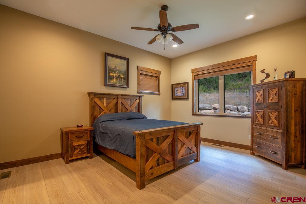 62 Manitou Lane Durango, CO 81301 - Photo 18 of 34 a bedroom with a bed and a dresser