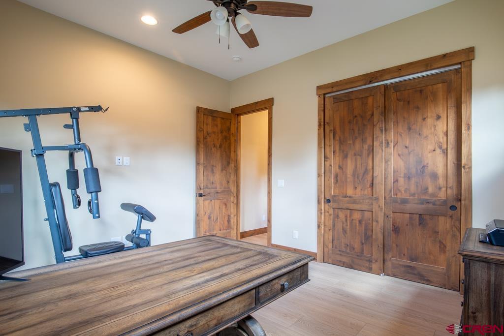 62 Manitou Lane Durango, CO 81301 - Photo 19 of 34 a bedroom with a bed and a mirror