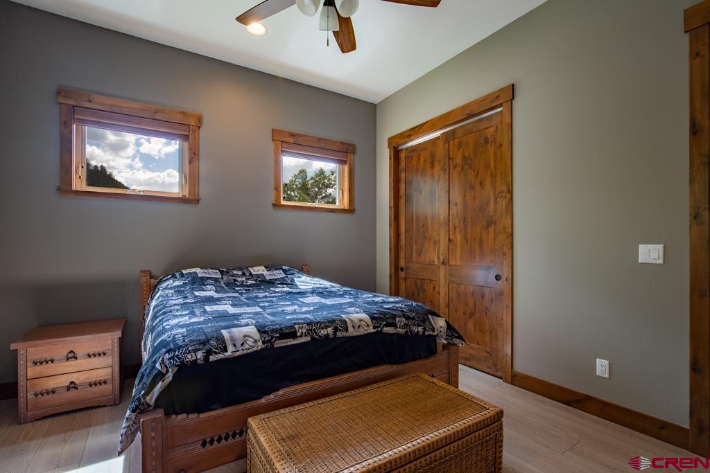 62 Manitou Lane Durango, CO 81301 - Photo 23 of 34 a bed sitting in a bedroom next to a window