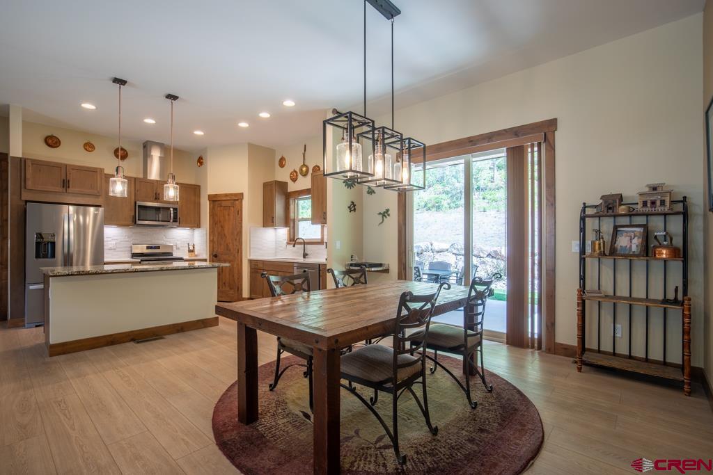 62 Manitou Lane Durango, CO 81301 - Photo 25 of 34 a kitchen with stainless steel appliances granite countertop a stove top oven a sink refrigerator and cabinets