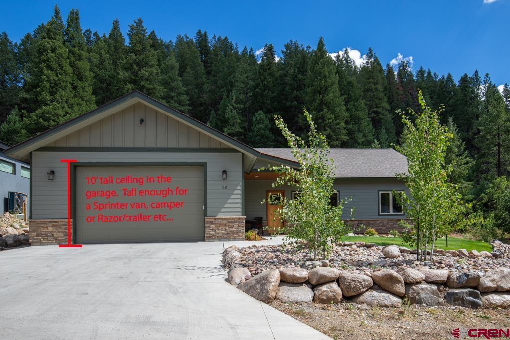 62 Manitou Lane Durango, CO 81301 - Photo 3 of 34 a front view of a house with a yard and garage