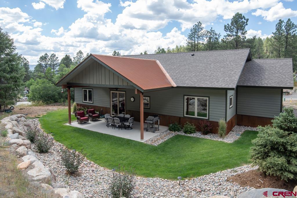 62 Manitou Lane Durango, CO 81301 - Photo 31 of 34 a view of a house with a yard fire pit and chairs