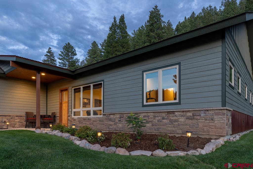62 Manitou Lane Durango, CO 81301 - Photo 34 of 34 a front view of a house with a garden and yard