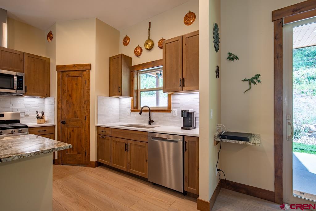 62 Manitou Lane Durango, CO 81301 - Photo 8 of 34 a bathroom with a granite countertop sink mirror and a shower