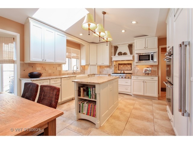 3320 Old Mill Road Northbrook, IL 60062 - Photo 5 of 16 a kitchen with a refrigerator sink and cabinets