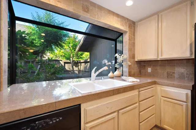 a kitchen with a sink and a large window