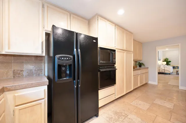 a kitchen with stainless steel appliances granite countertop a refrigerator and a stove