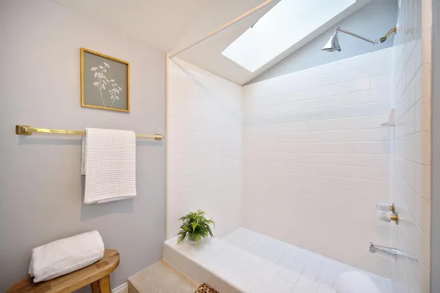 a bathroom with a shower curtain and a toilet
