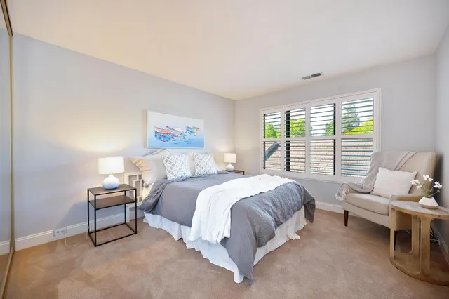 a bed room with a bed and a chair