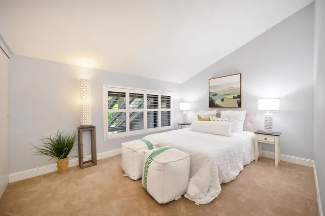 a bedroom with a large bed and a large window