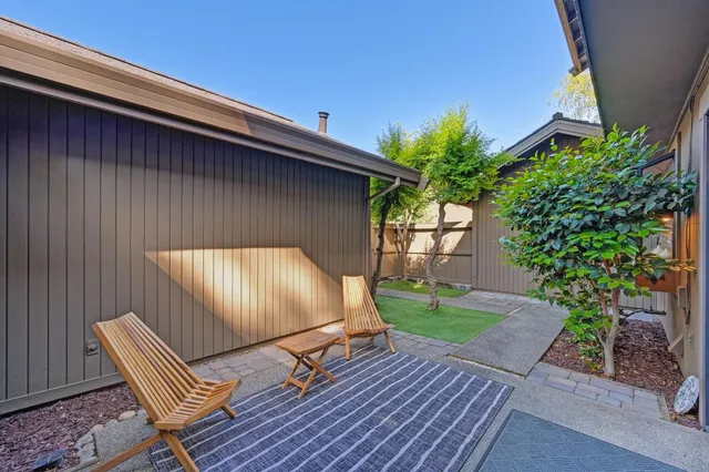 a view of a backyard with sitting area