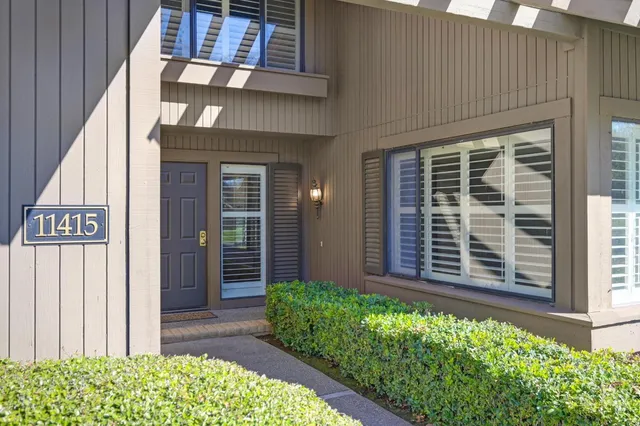 a view of a house with potted plants