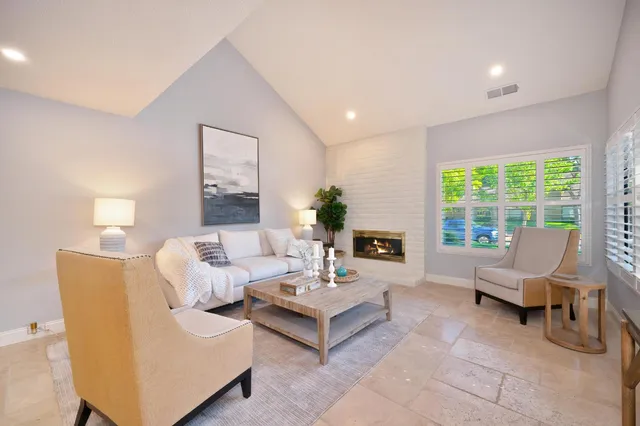 a living room with furniture and a large window