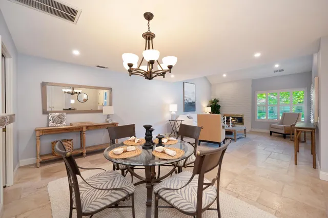 a view of a dining room with furniture and chandelier