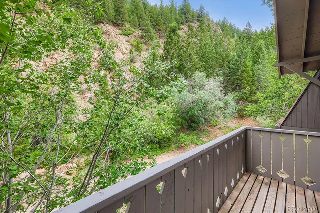 a balcony with trees in front of it