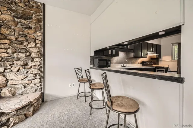 a kitchen with a table and chairs in it