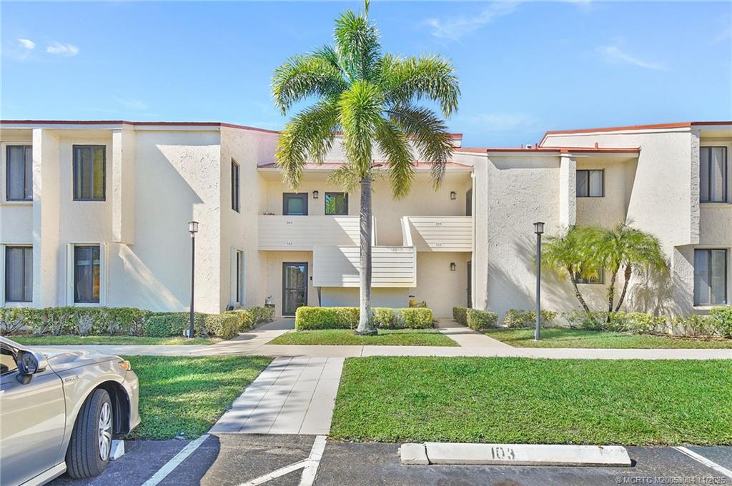 5111 Southeast Miles Grant Road, Unit 103 Stuart, FL 34997 - Photo 1 of 59 a view of outdoor space yard and front view of a house