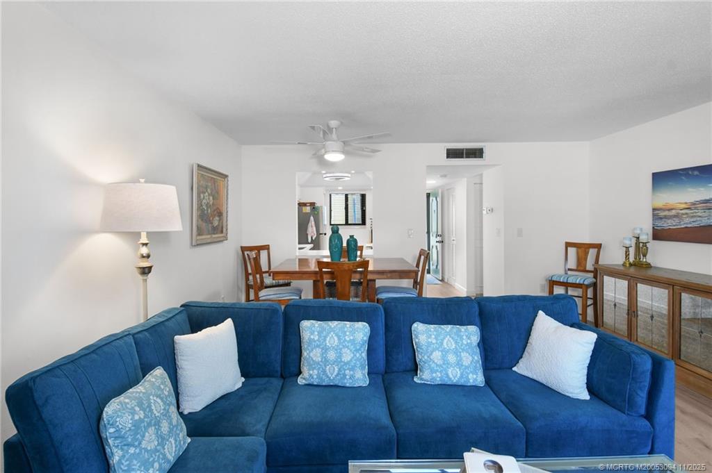 5111 Southeast Miles Grant Road, Unit 103 Stuart, FL 34997 - Photo 11 of 59 a living room with furniture and a table