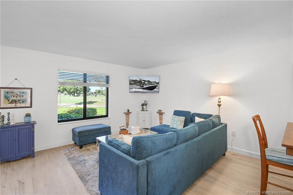 5111 Southeast Miles Grant Road, Unit 103 Stuart, FL 34997 - Photo 14 of 59 a living room with furniture and a window