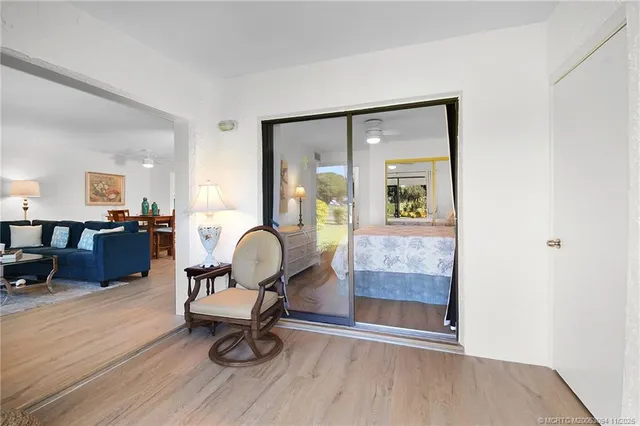 a view of a porch with furniture and floor to ceiling window