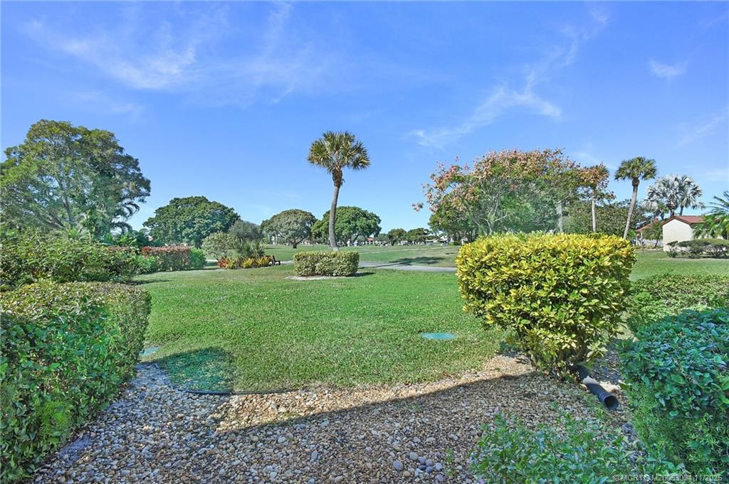 5111 Southeast Miles Grant Road, Unit 103 Stuart, FL 34997 - Photo 19 of 59 a view of a garden