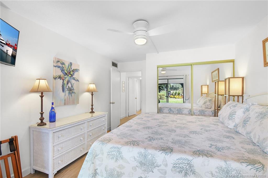 5111 Southeast Miles Grant Road, Unit 103 Stuart, FL 34997 - Photo 20 of 59 a bedroom with a bed and a window