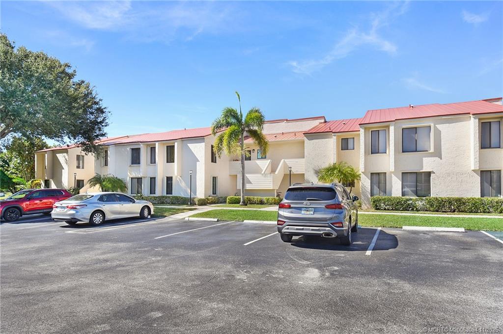 5111 Southeast Miles Grant Road, Unit 103 Stuart, FL 34997 - Photo 2 of 59 a car parked in front of a house