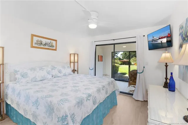 a bathroom with a sink a toilet a mirror and shower curtain