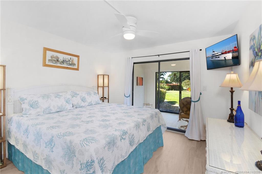 5111 Southeast Miles Grant Road, Unit 103 Stuart, FL 34997 - Photo 21 of 59 a bedroom with a bed and a walk in closet