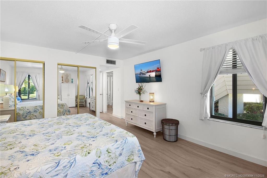 5111 Southeast Miles Grant Road, Unit 103 Stuart, FL 34997 - Photo 27 of 59 a bedroom with furniture and a window
