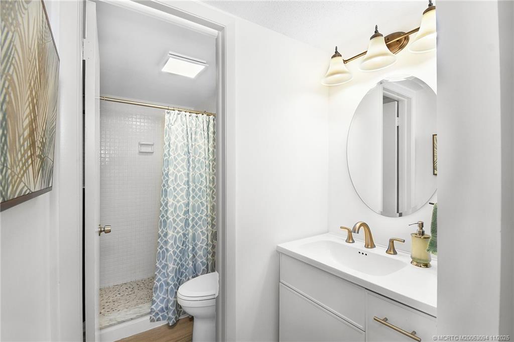 5111 Southeast Miles Grant Road, Unit 103 Stuart, FL 34997 - Photo 28 of 59 a bathroom with a sink a toilet and shower