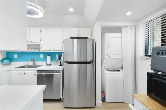 a view of a big house with swimming pool lawn chairs and a yard