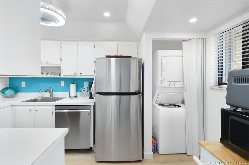 5111 Southeast Miles Grant Road, Unit 103 Stuart, FL 34997 - Photo 29 of 59 a white refrigerator freezer sitting in a kitchen