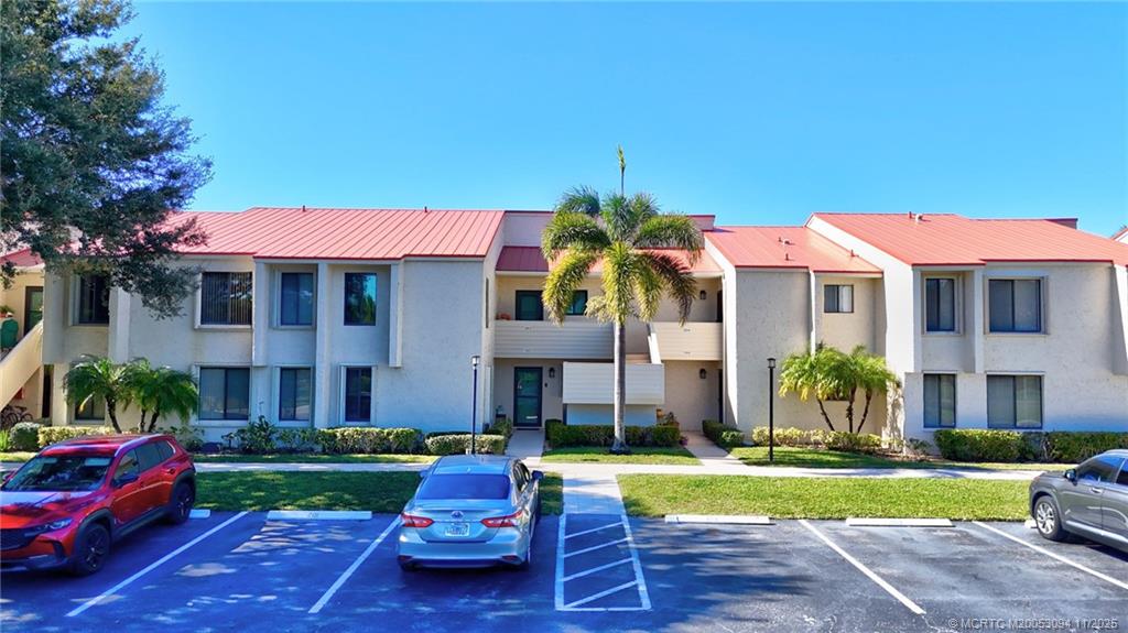 5111 Southeast Miles Grant Road, Unit 103 Stuart, FL 34997 - Photo 32 of 59 a front view of a house with garden
