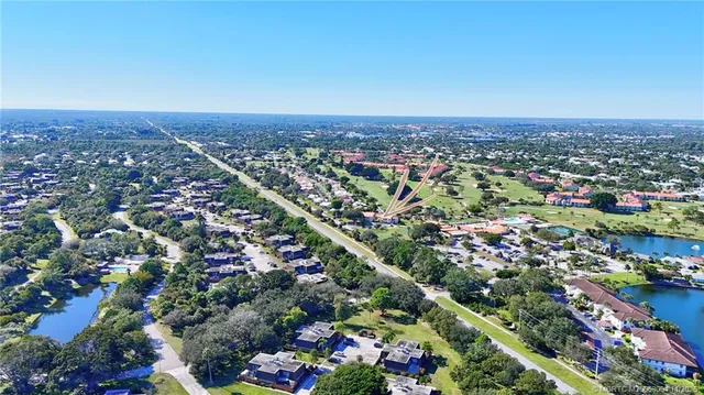 an aerial view of a golf course with parking space