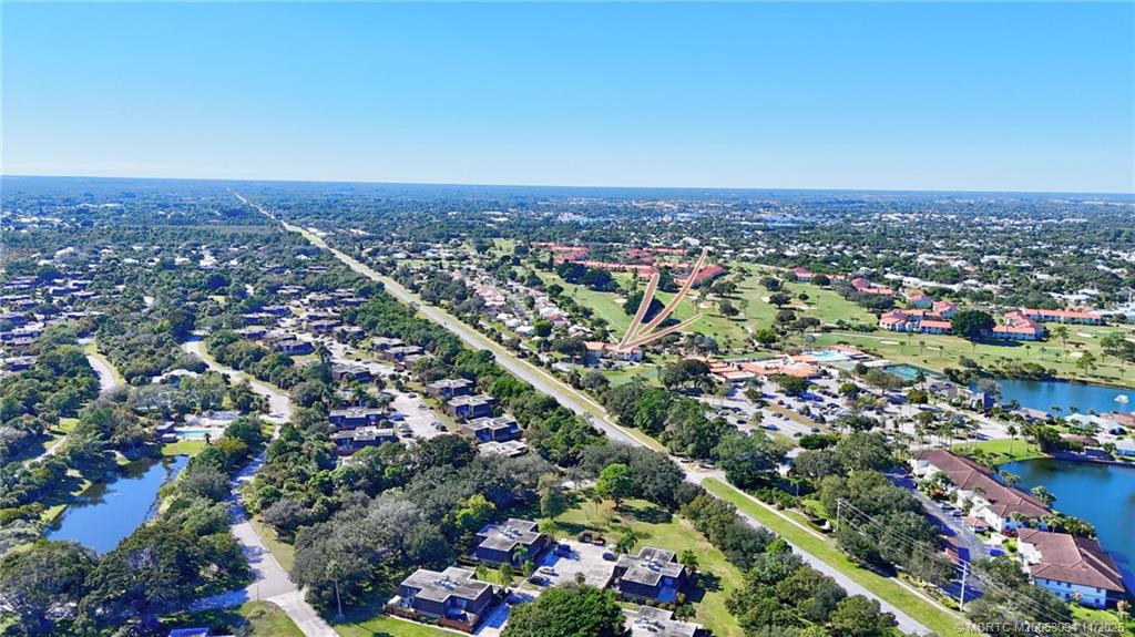 5111 Southeast Miles Grant Road, Unit 103 Stuart, FL 34997 - Photo 39 of 59 an aerial view of a city with lots of residential buildings