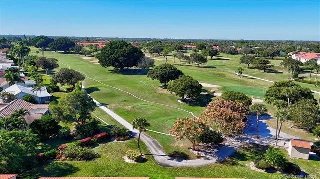 an aerial view of a city with lots of residential buildings and ocean view in back