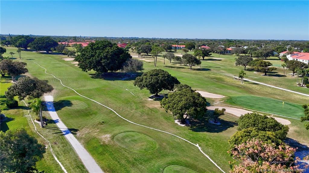 5111 Southeast Miles Grant Road, Unit 103 Stuart, FL 34997 - Photo 43 of 59 an aerial view of a golf course with parking space