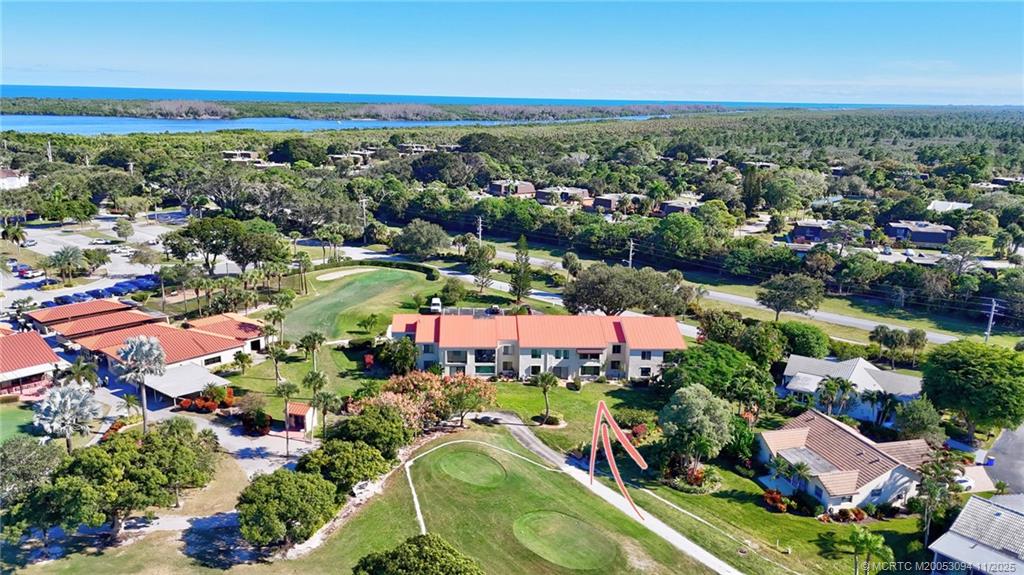 5111 Southeast Miles Grant Road, Unit 103 Stuart, FL 34997 - Photo 48 of 59 an aerial view of residential houses with outdoor space and trees