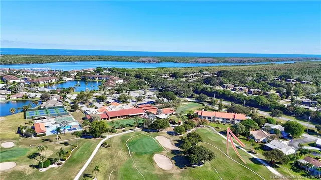 an aerial view of multi story residential apartment building with yard