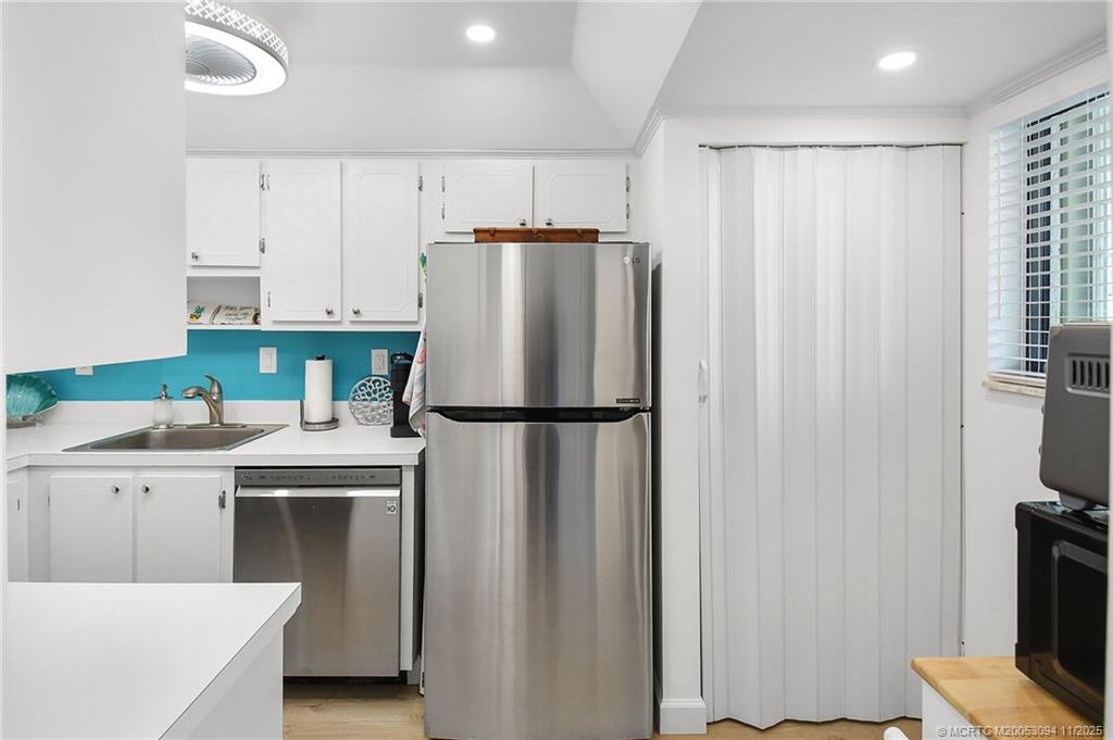 5111 Southeast Miles Grant Road, Unit 103 Stuart, FL 34997 - Photo 9 of 59 a kitchen with stainless steel appliances a refrigerator and a stove top oven