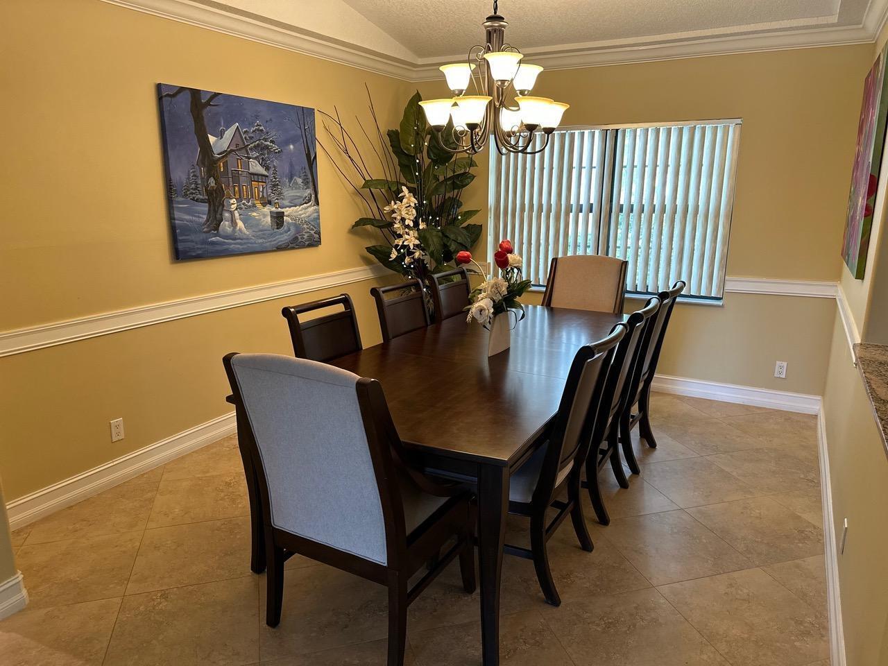 6594 Casabella Lane Boca Raton, FL 33433 - Photo 17 of 28 a view of a dining room with furniture and chandelier