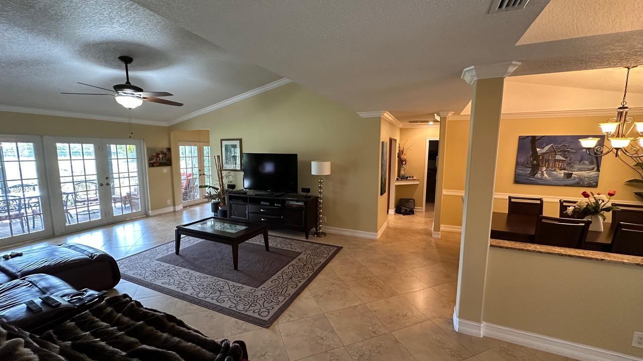 6594 Casabella Lane Boca Raton, FL 33433 - Photo 24 of 28 a living room with furniture and a flat screen tv
